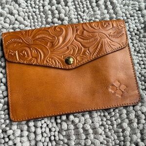 Patricia Nash clutch, embossed snap flap and rear outside zipper. Lined/ clean.